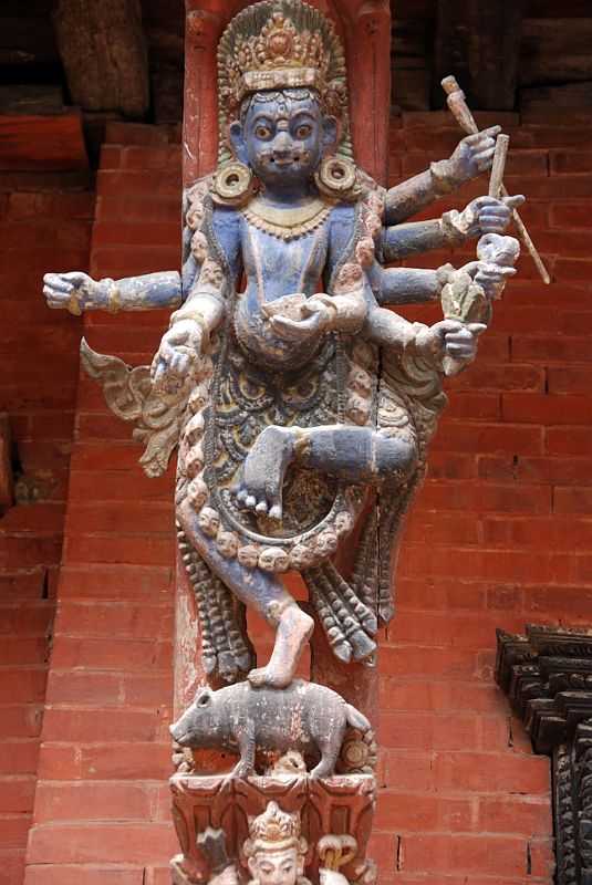 Kathmandu Patan Durbar Square Mul Chowk 23 Carved Wooden Roof Strut Of Many Armed Blue Wrathful Figure Standing On A Pig 